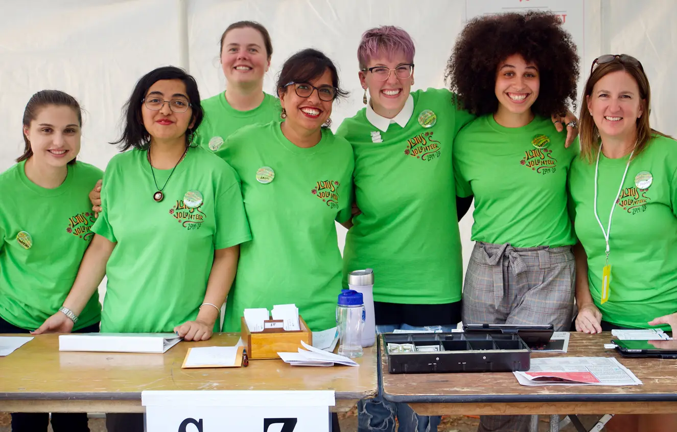 happy volunteers in green shirts