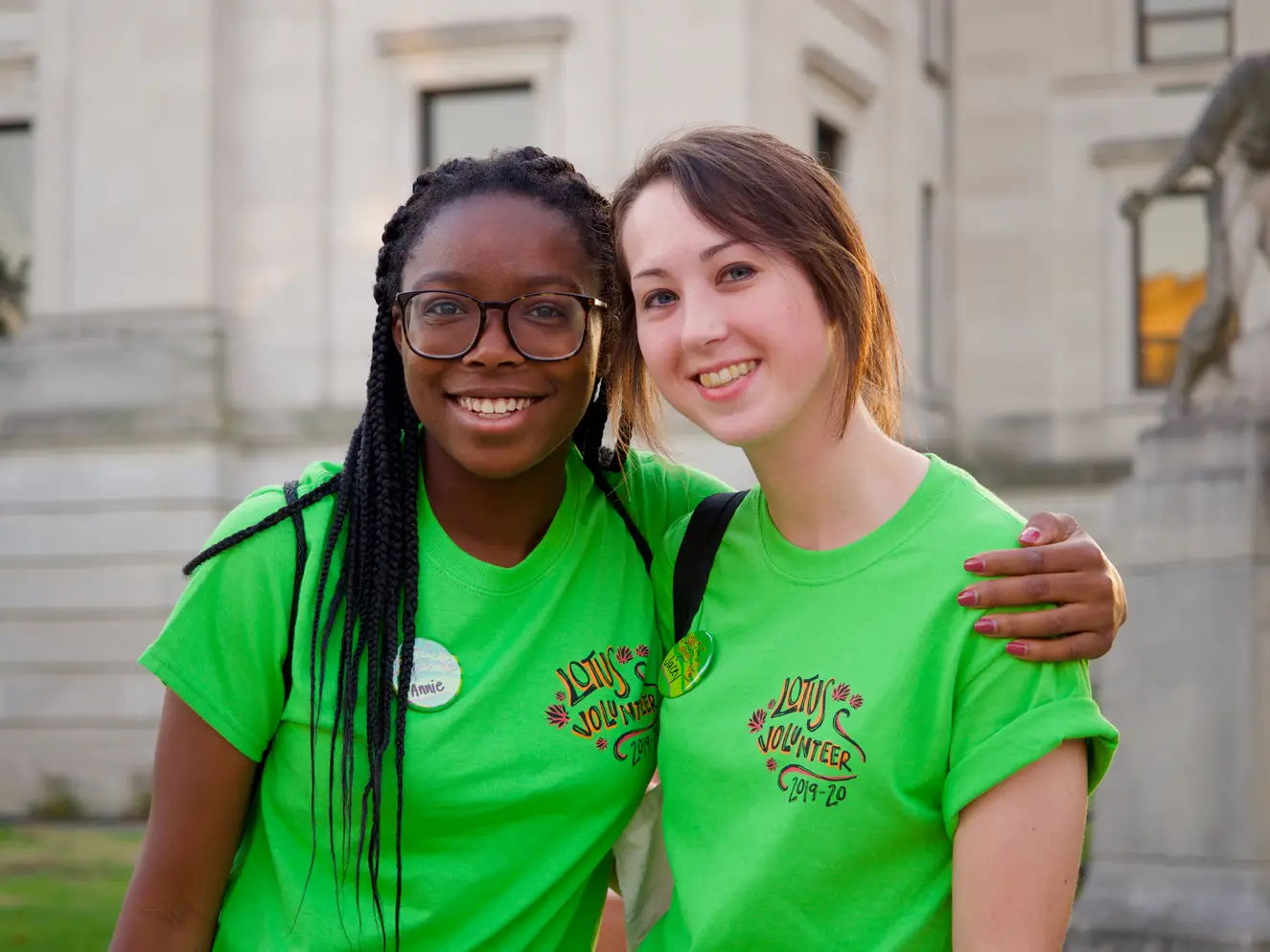 happy volunteers in green shirts