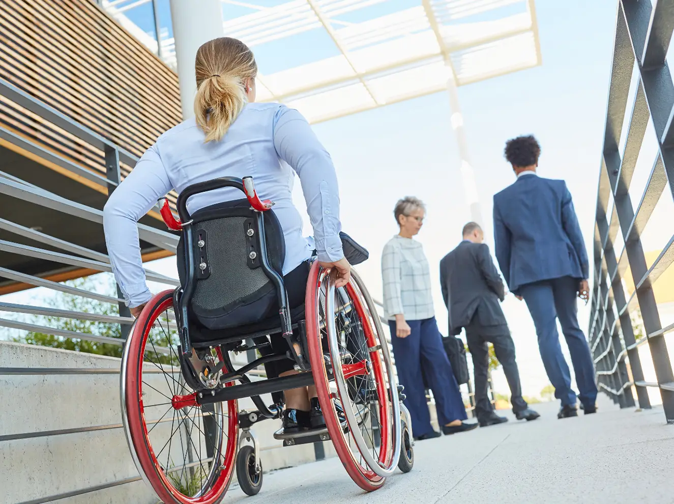 woman in a wheelchair moving up a ramp